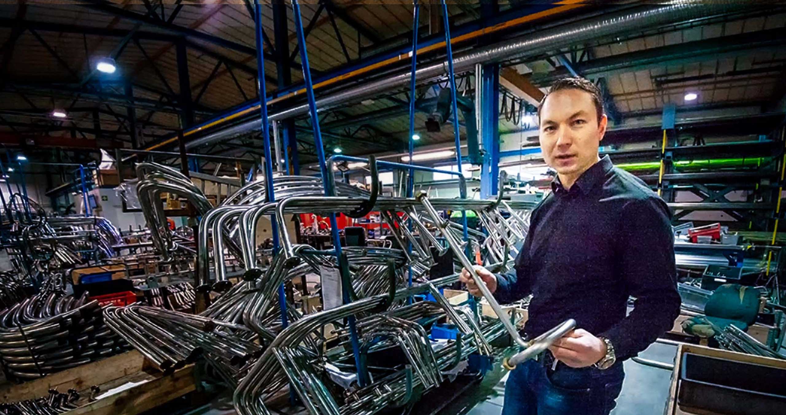 Toni Pesonen, Joros Oy's long-term pilot, presents bent pipes at the company's premises.